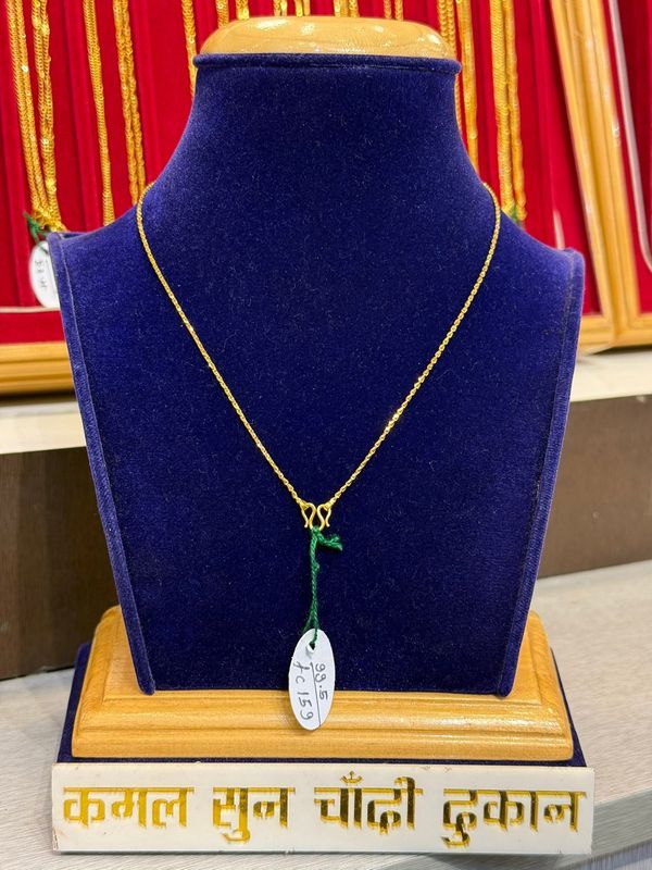 Fine linked chain with a simple clasp on a blue velvet stand